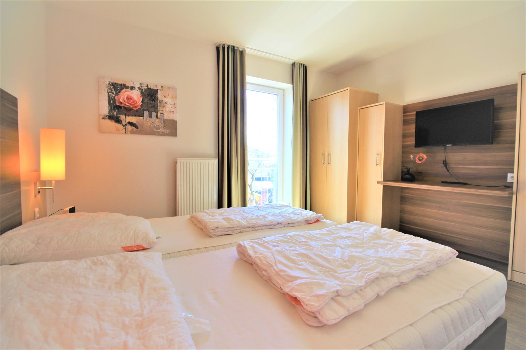 Schlafzimmer mit Fernseher der Ferienwohnung Hohe Lith 2.09